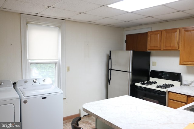 85 S St, Hanover, PA 17331 - kitchen featuring gas stove, freestanding refrigerator, light countertops, a drop ceiling, and washing machine and dryer