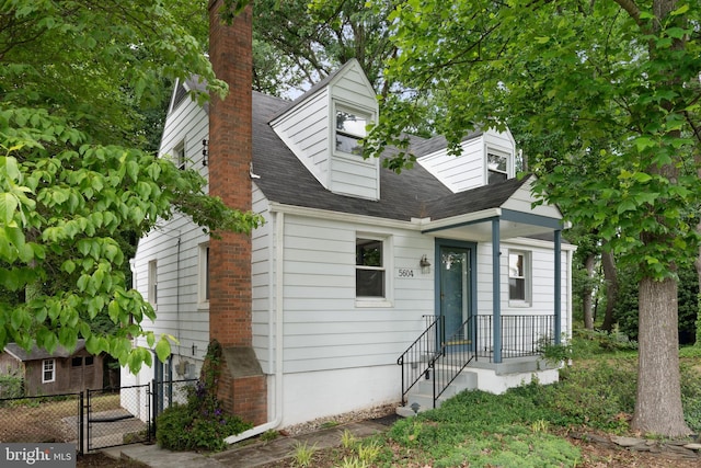 5604 Edgemont Dr, Alexandria, VA 22310 - cape cod home with a chimney, a gate, and roof with shingles
