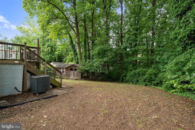 5604 Edgemont Dr, Alexandria, VA 22310 - view of yard featuring central AC, stairs, and an outdoor structure