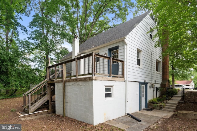 5604 Edgemont Dr, Alexandria, VA 22310 - view of side of home featuring stairway, roof with shingles, and a chimney