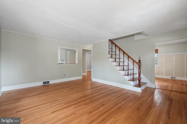 5604 Edgemont Dr, Alexandria, VA 22310 - unfurnished living room featuring light wood-type flooring, stairs, and baseboards