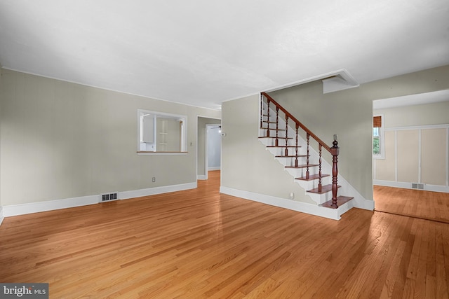 5604 Edgemont Dr, Alexandria, VA 22310 - unfurnished living room featuring light wood-type flooring, stairs, and baseboards