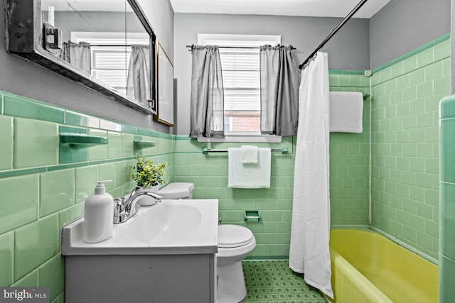 2521 Moore Ave, Baltimore, MD 21234 - bathroom with tile walls, toilet, shower / bathtub combination with curtain, vanity, and wainscoting