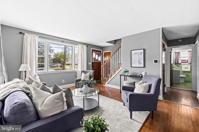 2521 Moore Ave, Baltimore, MD 21234 - living area with stairs, dark wood-type flooring, and baseboards