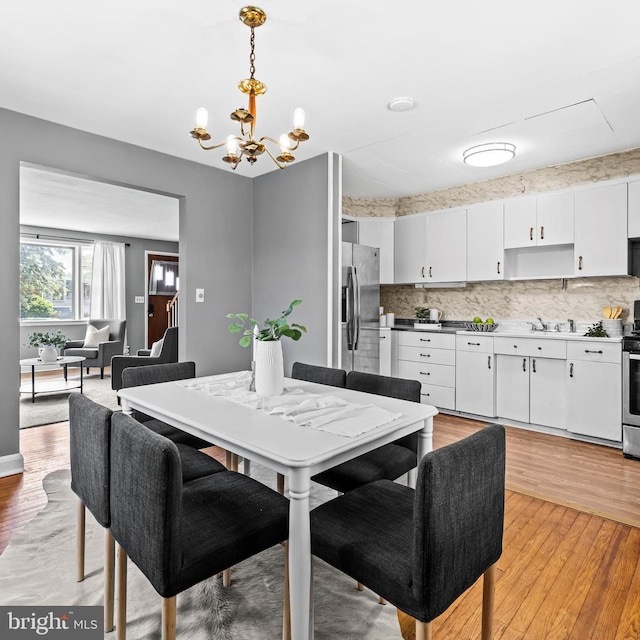 2521 Moore Ave, Baltimore, MD 21234 - dining space featuring a chandelier and light wood-style floors