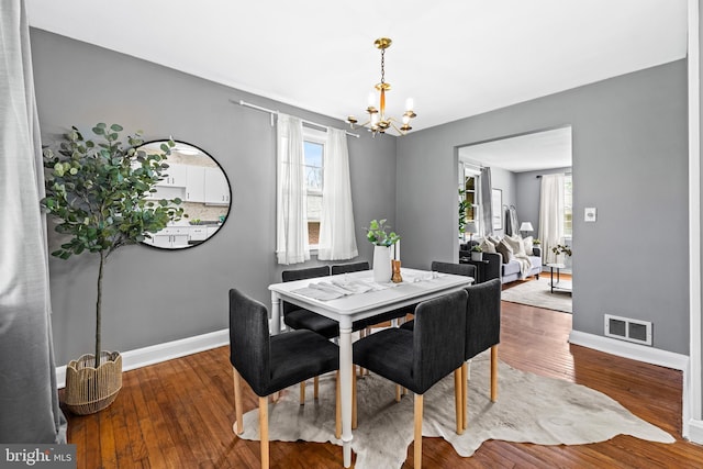 2521 Moore Ave, Baltimore, MD 21234 - dining area featuring a chandelier, baseboards, and wood-type flooring