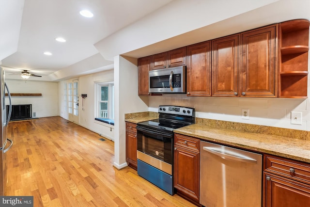 46 Misty Ln, Stafford, VA 22556 - kitchen featuring stainless steel appliances, ceiling fan, light wood-type flooring, a brick fireplace, and light stone countertops