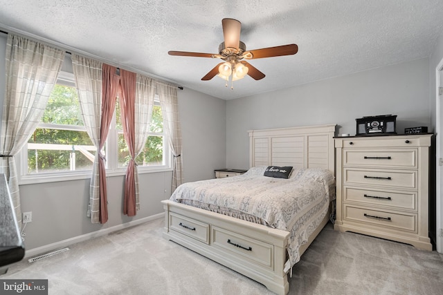 27073 Carrie Ct, Mechanicsville, MD 20659 - bedroom featuring light colored carpet, multiple windows, a textured ceiling, baseboards, and ceiling fan