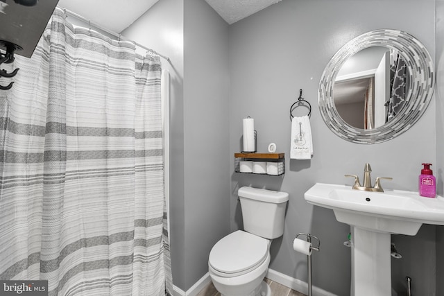 27073 Carrie Ct, Mechanicsville, MD 20659 - full bath with toilet, baseboards, wood finished floors, and curtained shower