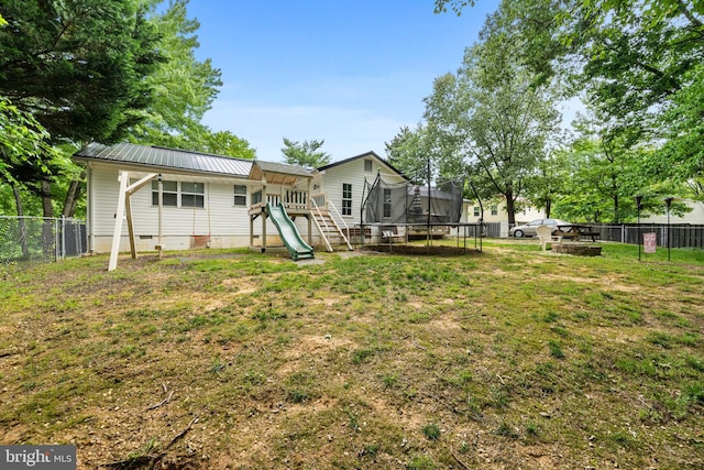 27073 Carrie Ct, Mechanicsville, MD 20659 - rear view of property featuring a trampoline, a playground, metal roof, and crawl space