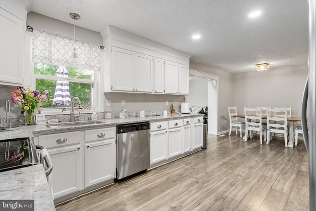 27073 Carrie Ct, Mechanicsville, MD 20659 - kitchen with appliances with stainless steel finishes, a sink, a textured ceiling, white cabinetry, and light wood-type flooring