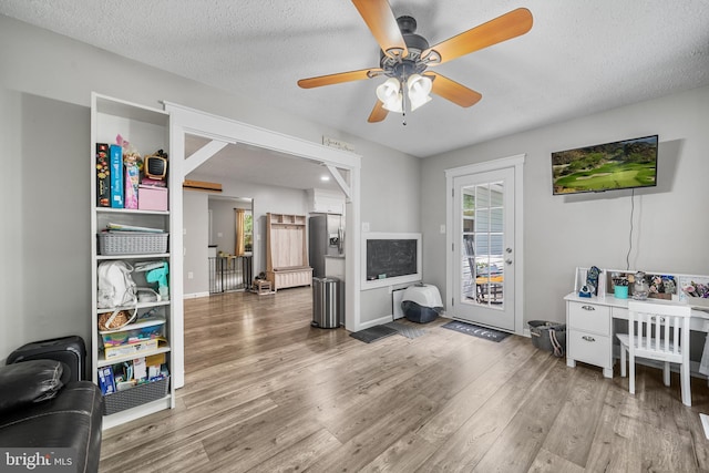 27073 Carrie Ct, Mechanicsville, MD 20659 - living room featuring radiator, wood finished floors, ceiling fan, and a textured ceiling