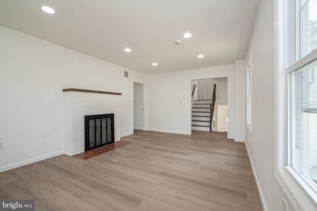2400 Maurice St, Port Norris, NJ 08349 - unfurnished living room with stairway, light wood-style flooring, recessed lighting, a fireplace, and baseboards