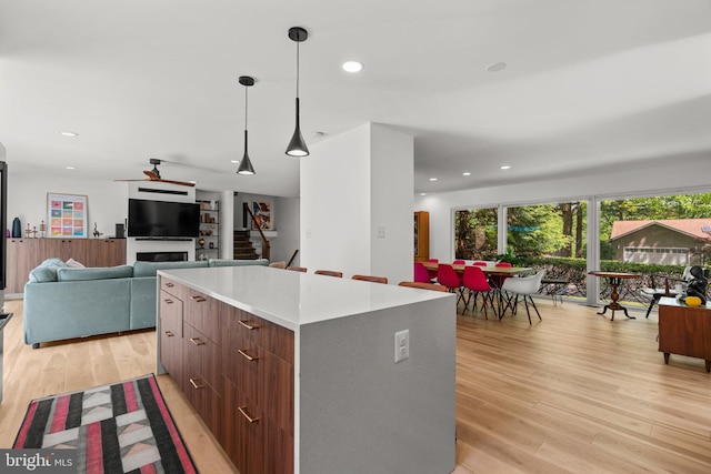 11111 Willow Bottom Dr, Columbia, MD 21044 - kitchen featuring a center island, light wood-style floors, open floor plan, pendant lighting, and recessed lighting