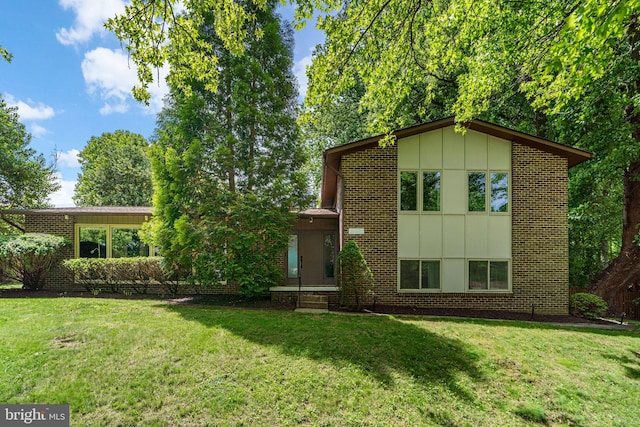 11111 Willow Bottom Dr, Columbia, MD 21044 - view of front of property with brick siding, a front lawn, and board and batten siding