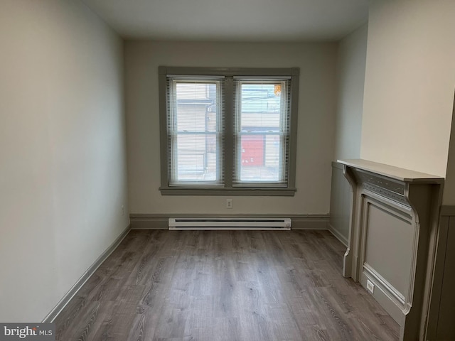 3 Third St, Pottstown, PA 19464 - unfurnished living room with baseboard heating, wood finished floors, and baseboards