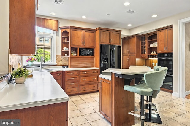 826 Bent Creek Dr, Lititz, PA 17543 - kitchen featuring open shelves, a sink, black appliances, a breakfast bar, and light countertops