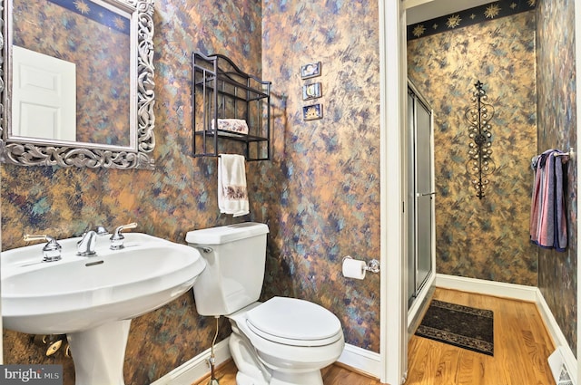 826 Bent Creek Dr, Lititz, PA 17543 - bathroom with baseboards, wood finished floors, a shower stall, toilet, and wallpapered walls