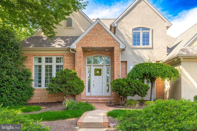 826 Bent Creek Dr, Lititz, PA 17543 - view of front of house with stucco siding, brick siding, and roof with shingles