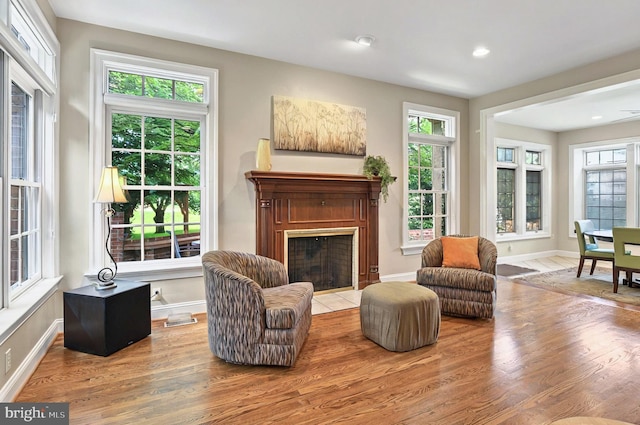 826 Bent Creek Dr, Lititz, PA 17543 - living area with a fireplace with flush hearth, wood finished floors, baseboards, and recessed lighting