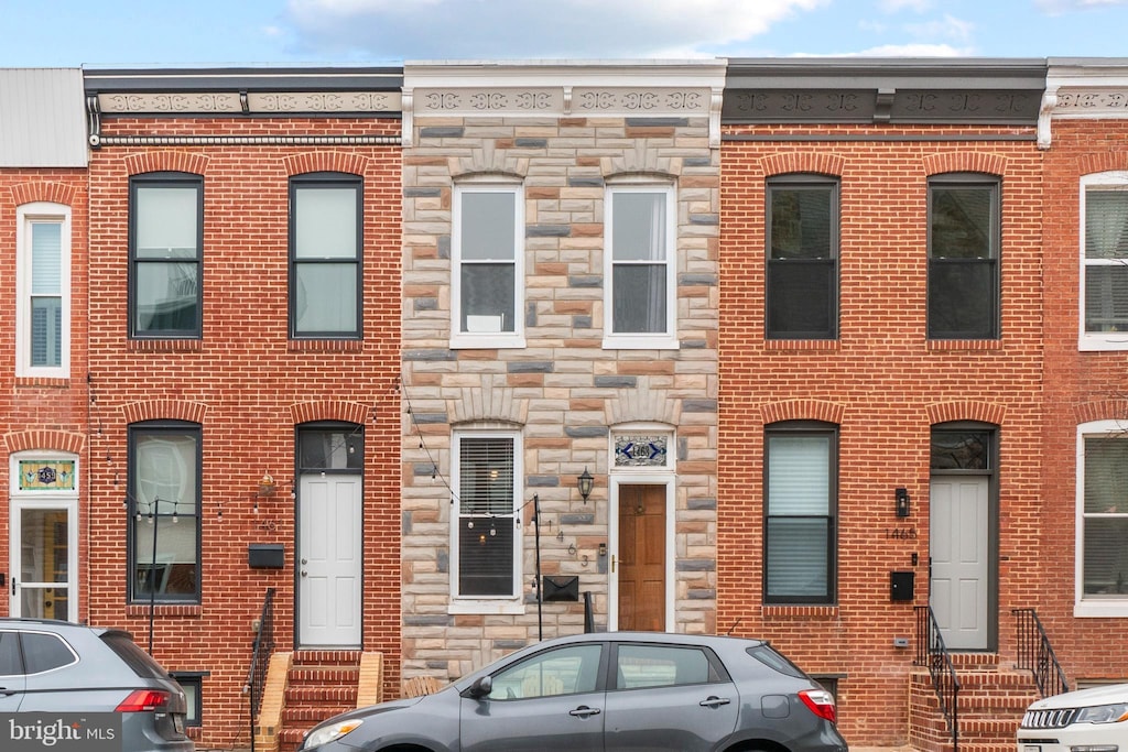 1463 Towson St, Baltimore, MD 21230 - view of property featuring entry steps, stone siding, and brick siding