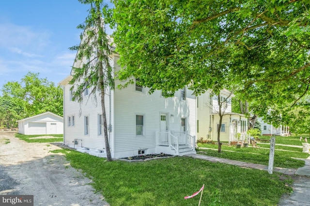 395 Main St, Cedarville, NJ 08311 - townhome / multi-family property featuring an outdoor structure, a front lawn, and a detached garage