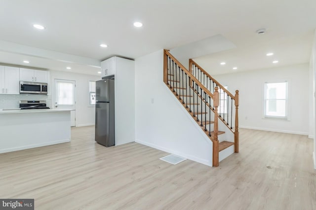 395 Main St, Cedarville, NJ 08311 - kitchen featuring appliances with stainless steel finishes, light wood-style floors, white cabinetry, and recessed lighting
