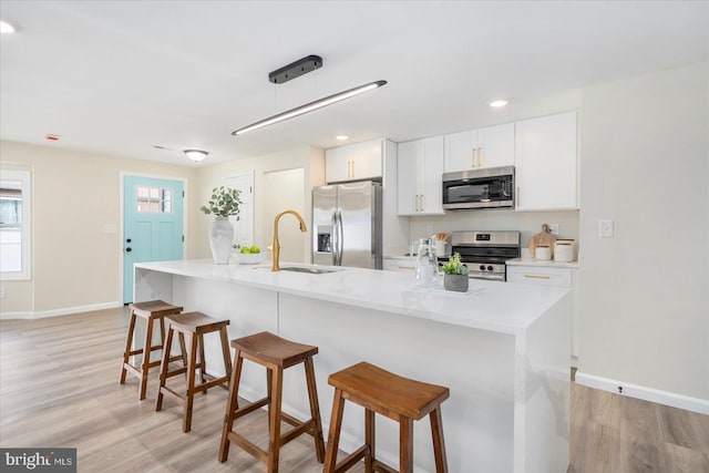 214 Kennard Ave, Edgewood, MD 21040 - kitchen featuring appliances with stainless steel finishes, a sink, baseboards, light wood-style floors, and recessed lighting