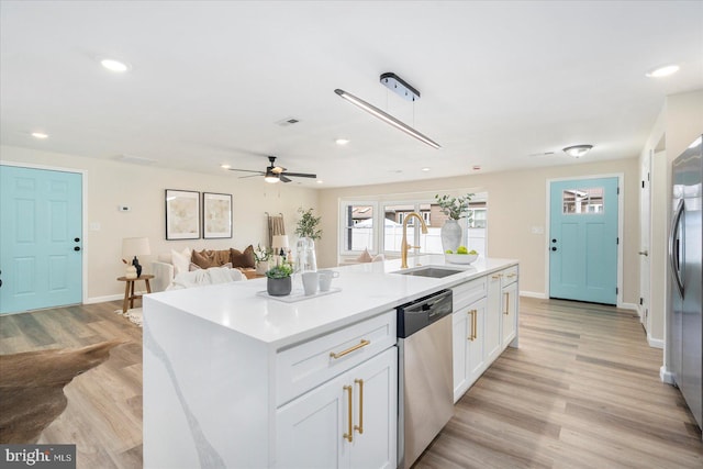 214 Kennard Ave, Edgewood, MD 21040 - kitchen with stainless steel appliances, a sink, white cabinetry, light wood-type flooring, and baseboards