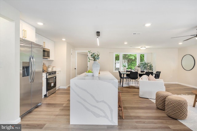 214 Kennard Ave, Edgewood, MD 21040 - kitchen with stainless steel appliances, white cabinets, open floor plan, light wood-type flooring, and recessed lighting