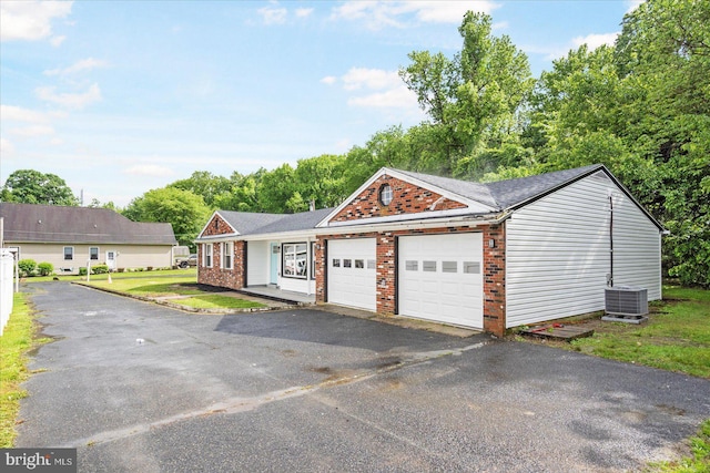 214 Kennard Ave, Edgewood, MD 21040 - view of front of home with a garage, brick siding, asphalt driveway, and central AC