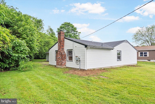 214 Kennard Ave, Edgewood, MD 21040 - view of home's exterior featuring a chimney and a yard