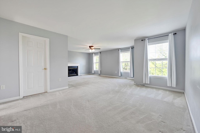 82 Grayson Ave, East Earl, PA 17519 - unfurnished living room featuring a ceiling fan, carpet, baseboards, and a glass covered fireplace