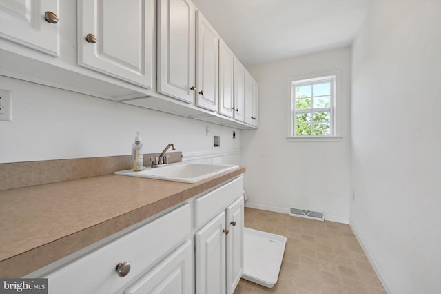 82 Grayson Ave, East Earl, PA 17519 - laundry area with baseboards, washer hookup, cabinet space, electric dryer hookup, and light floors