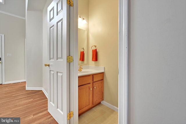82 Grayson Ave, East Earl, PA 17519 - bathroom featuring ornamental molding, vanity, baseboards, and wood finished floors