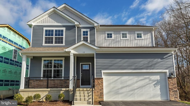 139 Erica Ln, Columbia, PA 17512 - craftsman-style home with covered porch, an attached garage, board and batten siding, and asphalt driveway