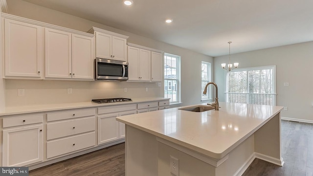139 Erica Ln, Columbia, PA 17512 - kitchen featuring stainless steel microwave, a sink, gas stovetop, dark wood-type flooring, and white cabinetry