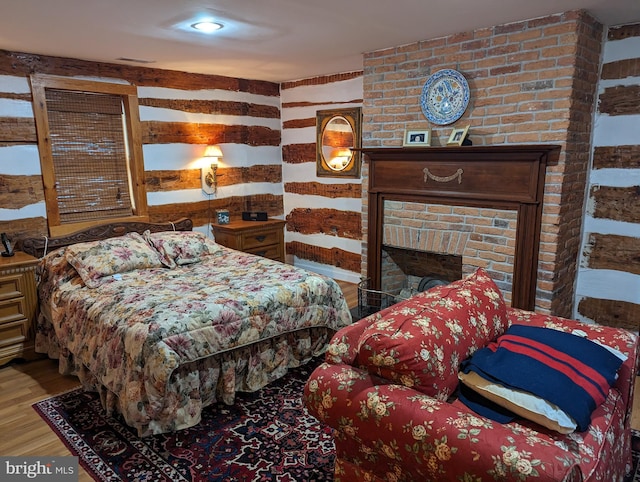 2834 E Boss Arnold Rd, Jefferson, MD 21755 - bedroom featuring wood finished floors and a brick fireplace