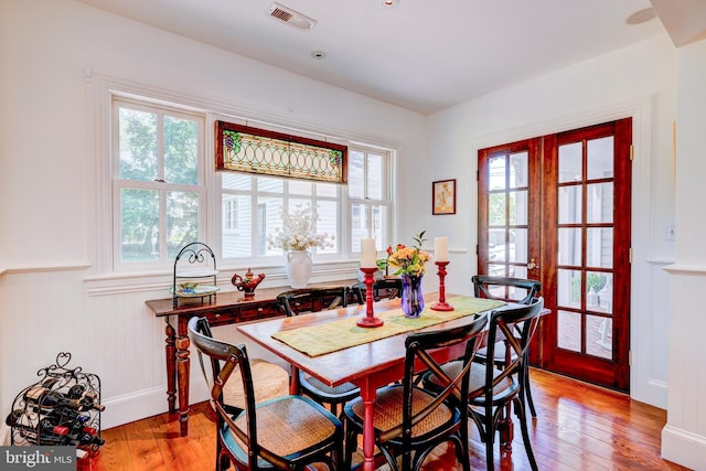 315 Linden Ave, Doylestown, PA 18901 - dining space with plenty of natural light, light wood finished floors, a wainscoted wall, and a decorative wall