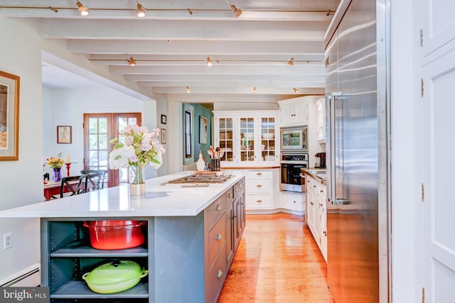 315 Linden Ave, Doylestown, PA 18901 - kitchen with built in appliances, open shelves, light wood finished floors, a kitchen island, and white cabinets