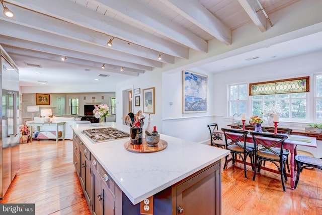 315 Linden Ave, Doylestown, PA 18901 - kitchen featuring stainless steel gas stovetop, light wood finished floors, beamed ceiling, a center island, and light countertops