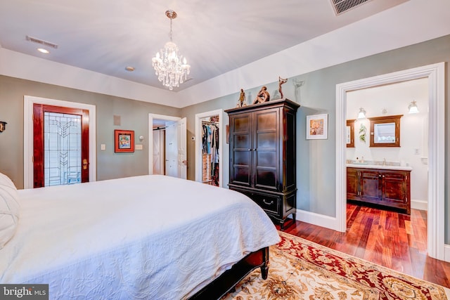 315 Linden Ave, Doylestown, PA 18901 - bedroom with wood finished floors, a chandelier, baseboards, a walk in closet, and ensuite bathroom