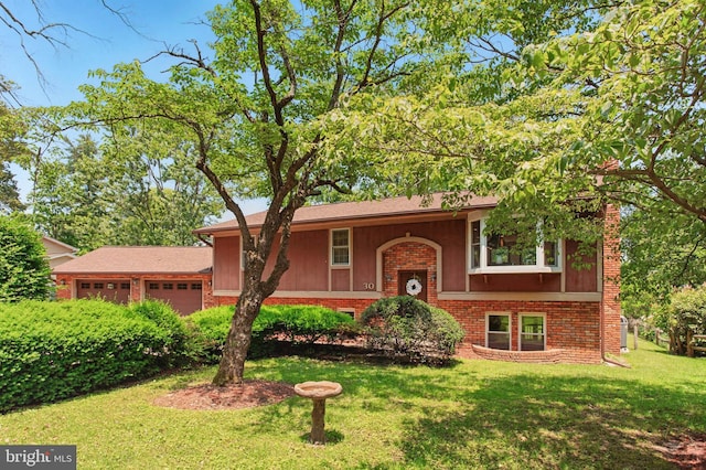 30 Pennsylvania Ave, Edgewater, MD 21037 - view of front of house featuring brick siding, a garage, a front lawn, and board and batten siding