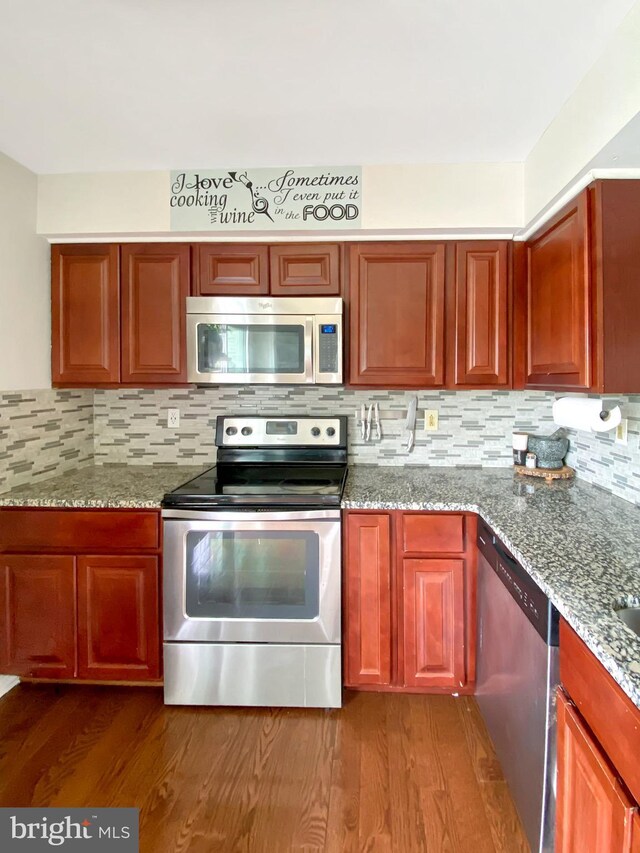 6600 Brave Ct, Haymarket, VA 20169 - kitchen with appliances with stainless steel finishes, decorative backsplash, and dark wood-type flooring