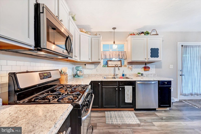 96 Billerbeck St, New Oxford, PA 17350 - kitchen featuring appliances with stainless steel finishes, a sink, light wood-style floors, and white cabinetry