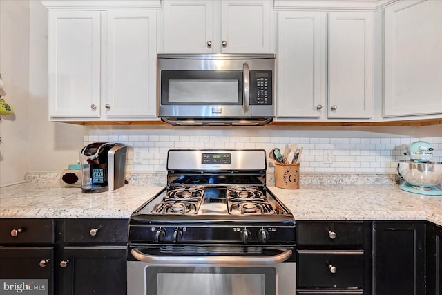 96 Billerbeck St, New Oxford, PA 17350 - kitchen with stainless steel appliances, dark cabinetry, tasteful backsplash, and white cabinets