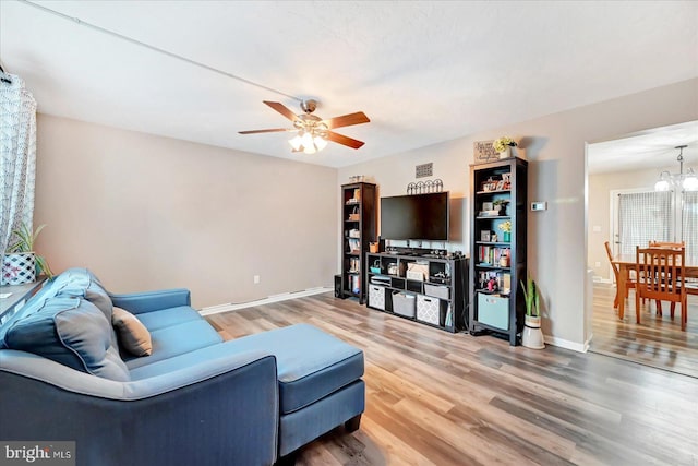 96 Billerbeck St, New Oxford, PA 17350 - living area with a chandelier, light wood finished floors, ceiling fan, and baseboards