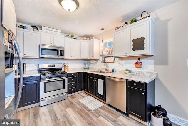 96 Billerbeck St, New Oxford, PA 17350 - kitchen with stainless steel appliances, a sink, white cabinetry, and dark cabinetry