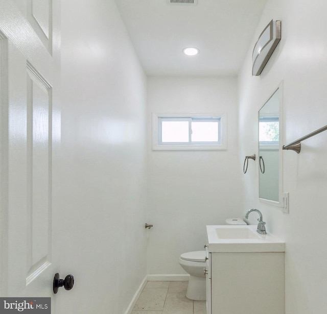 229 Shoemaker Rd, Bridgeton, NJ 08302 - half bath with plenty of natural light, toilet, vanity, and baseboards