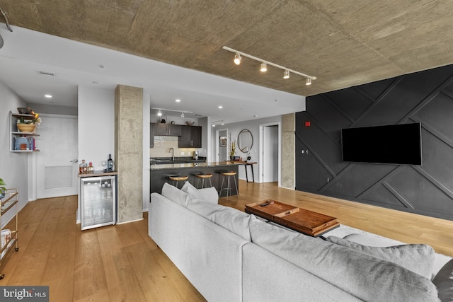 1200 Steuart St Unit 326, Baltimore, MD 21230 - living room featuring wine cooler, light wood-style floors, and a dry bar